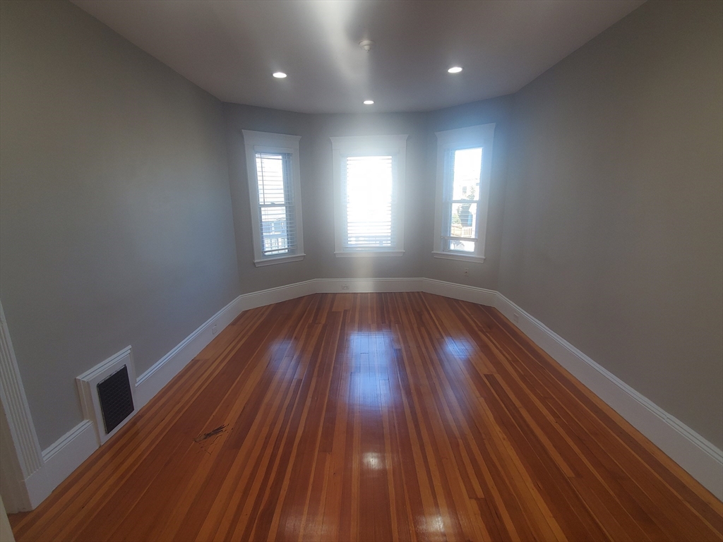 14 North Munroe Terrace, Unit 2 Boston, MA 02122 - Photo 6 of 19 a view of wooden floor and windows in a room