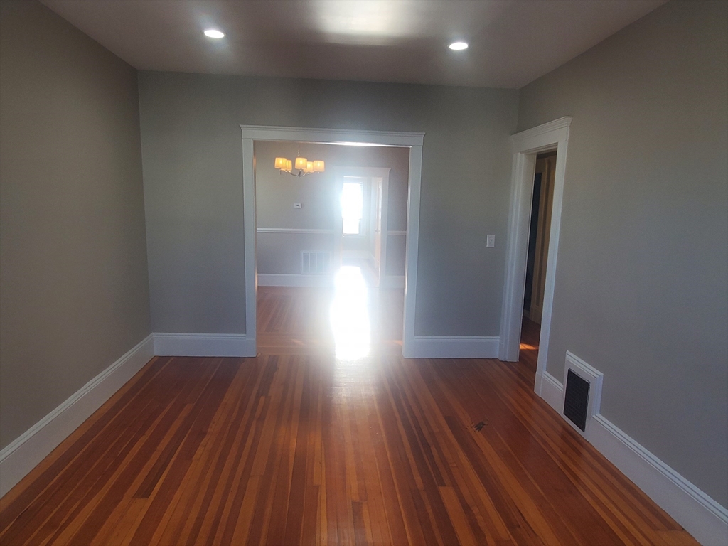 14 North Munroe Terrace, Unit 2 Boston, MA 02122 - Photo 7 of 19 a view of empty room with wooden floor