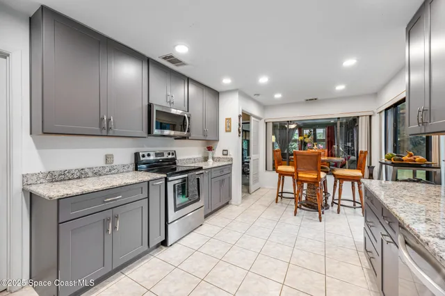 a living room with furniture a rug and a chandelier