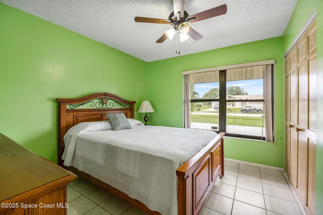a bedroom with a bed a table and chair