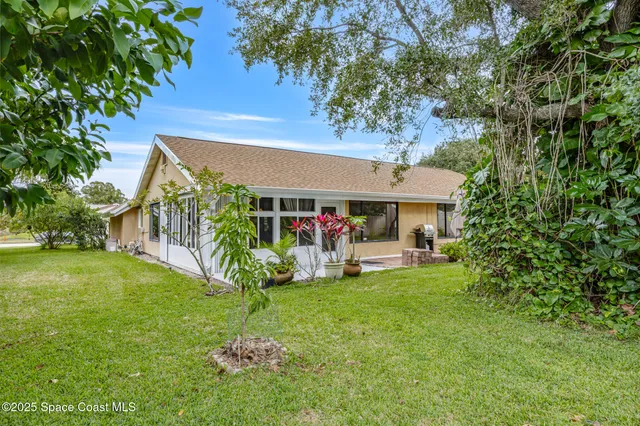 a view of a house with a backyard and garden