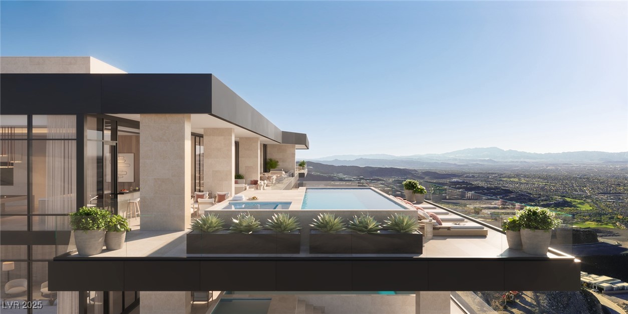Balcony featuring a mountain view and view of pool area