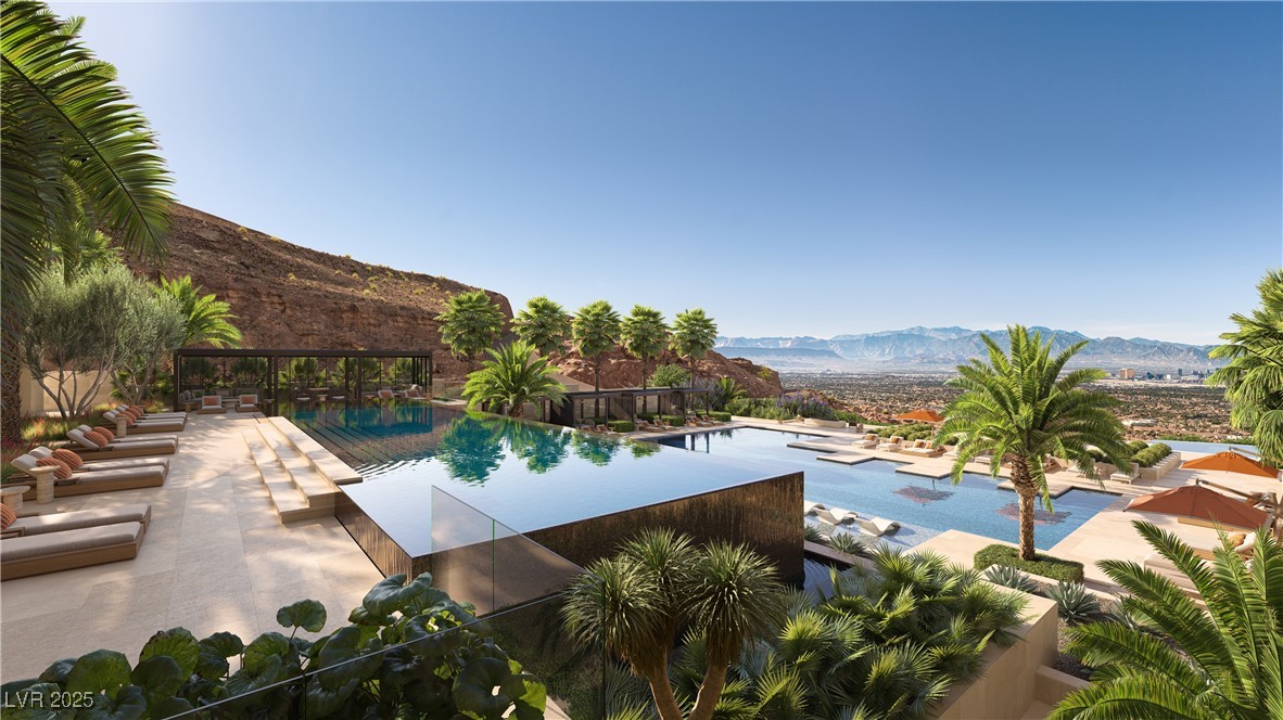 410 Rock Peak Drive, Unit 2402 Henderson, NV 89012 - Photo 2 of 11 Community pool with a mountain view and a patio area