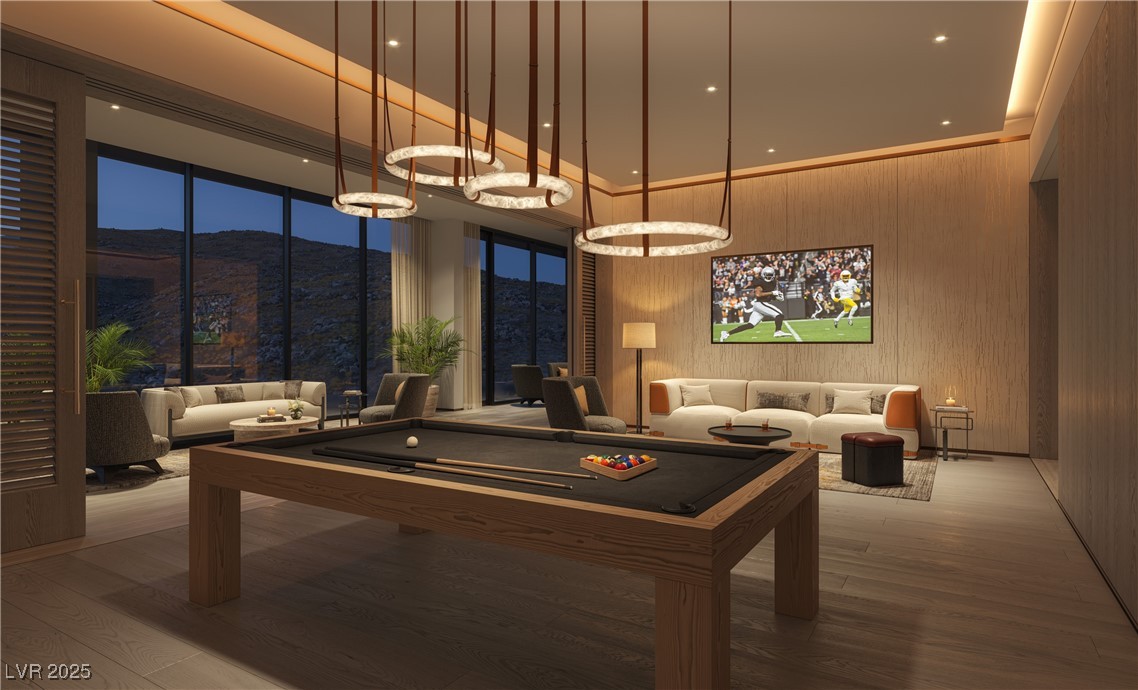 410 Rock Peak Drive, Unit 2402 Henderson, NV 89012 - Photo 4 of 11 Rec room featuring wood finished floors, a mountain view, a towering ceiling, billiards, and wooden walls