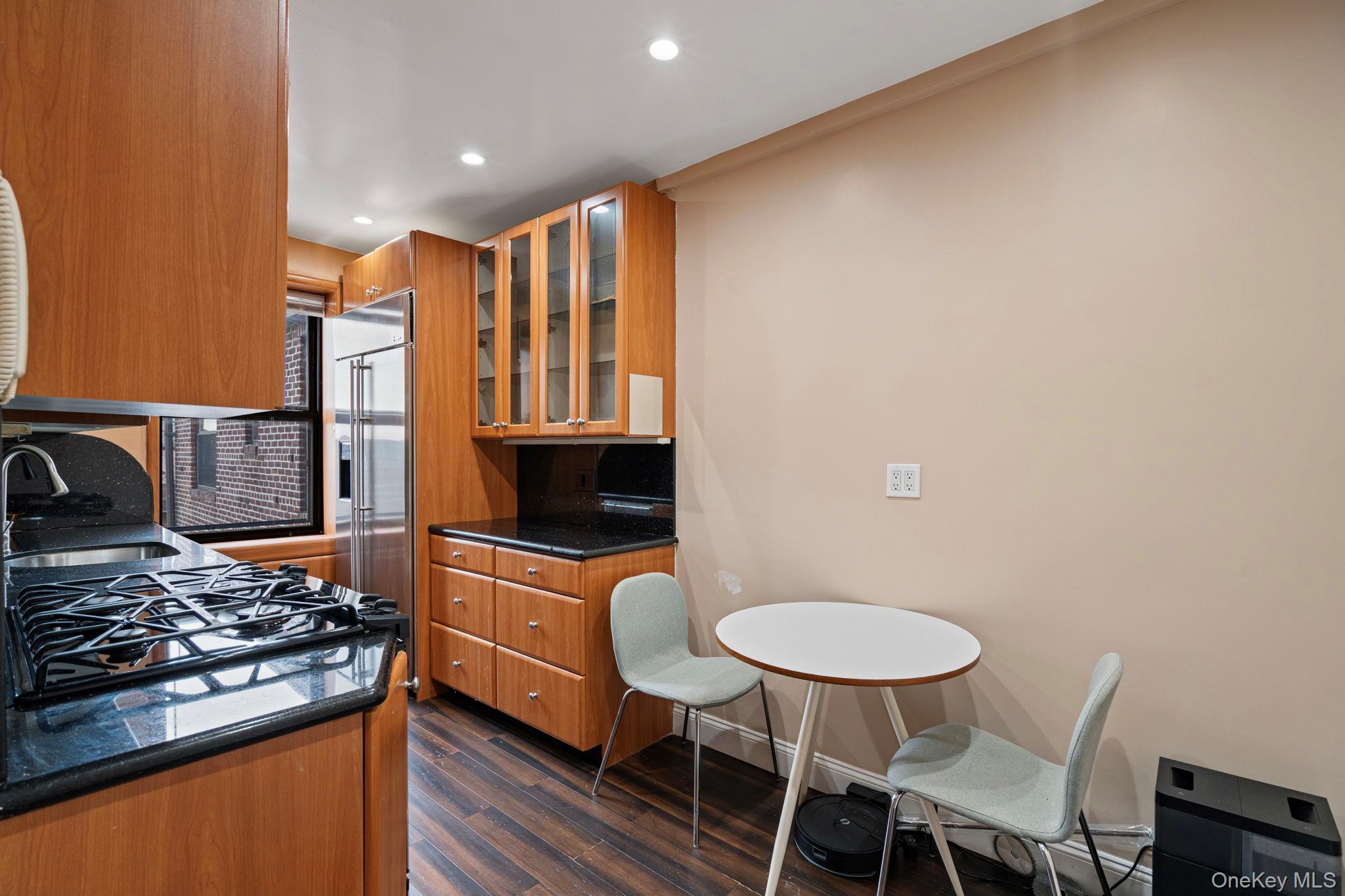 77-15 Ditmars Boulevard, Unit B2 Queens, NY 11370 - Photo 12 of 24 a kitchen with a stove and a chair