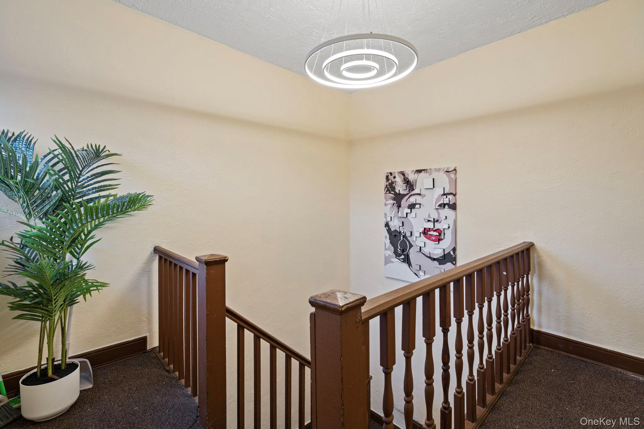 77-15 Ditmars Boulevard, Unit B2 Queens, NY 11370 - Photo 17 of 24 a view of a hallway with wooden floor
