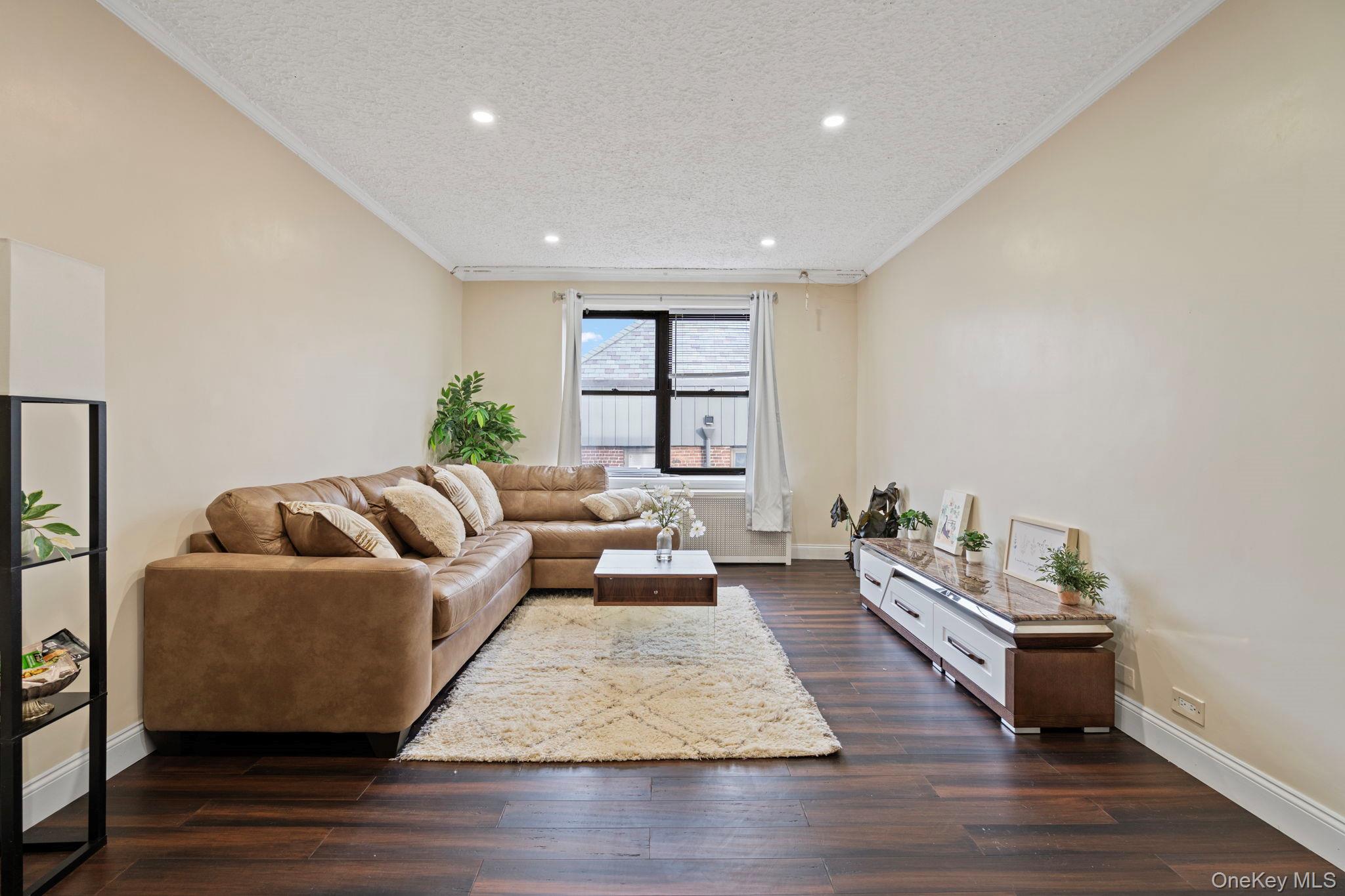 77-15 Ditmars Boulevard, Unit B2 Queens, NY 11370 - Photo 2 of 24 a living room with furniture and a wooden floor