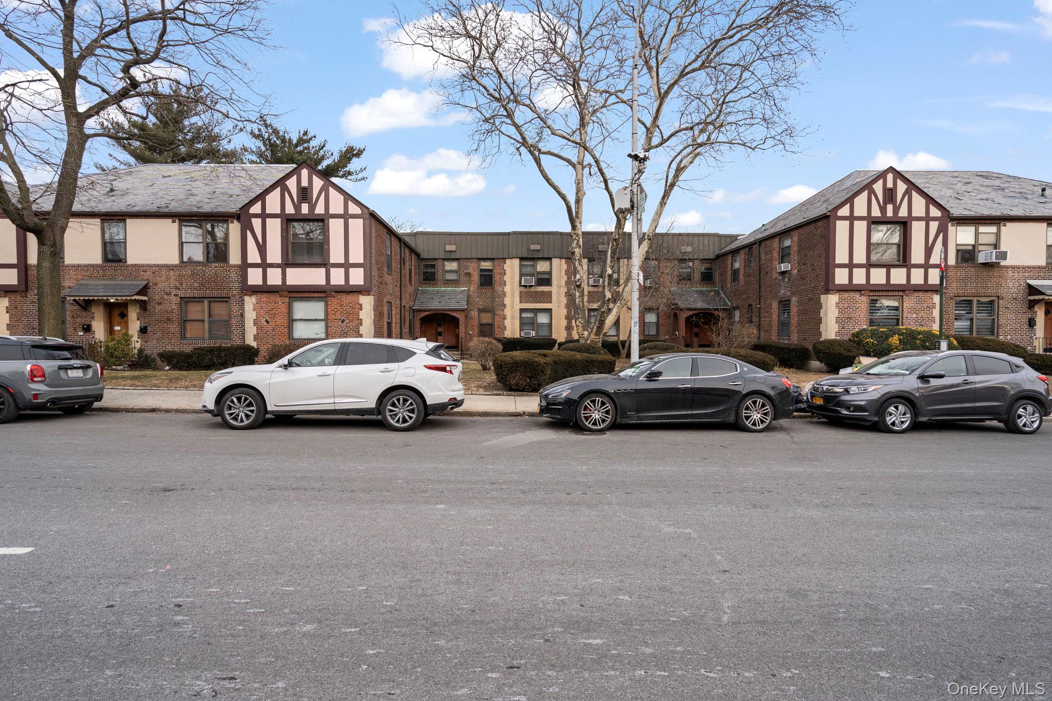 77-15 Ditmars Boulevard, Unit B2 Queens, NY 11370 - Photo 21 of 24 a view of cars parked in front of a house