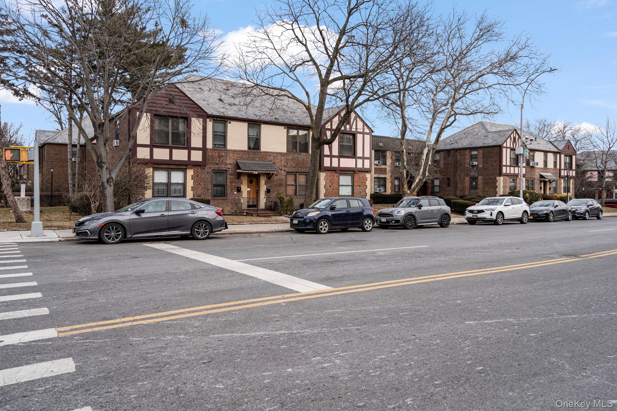 77-15 Ditmars Boulevard, Unit B2 Queens, NY 11370 - Photo 22 of 24 a building with trees in front of it