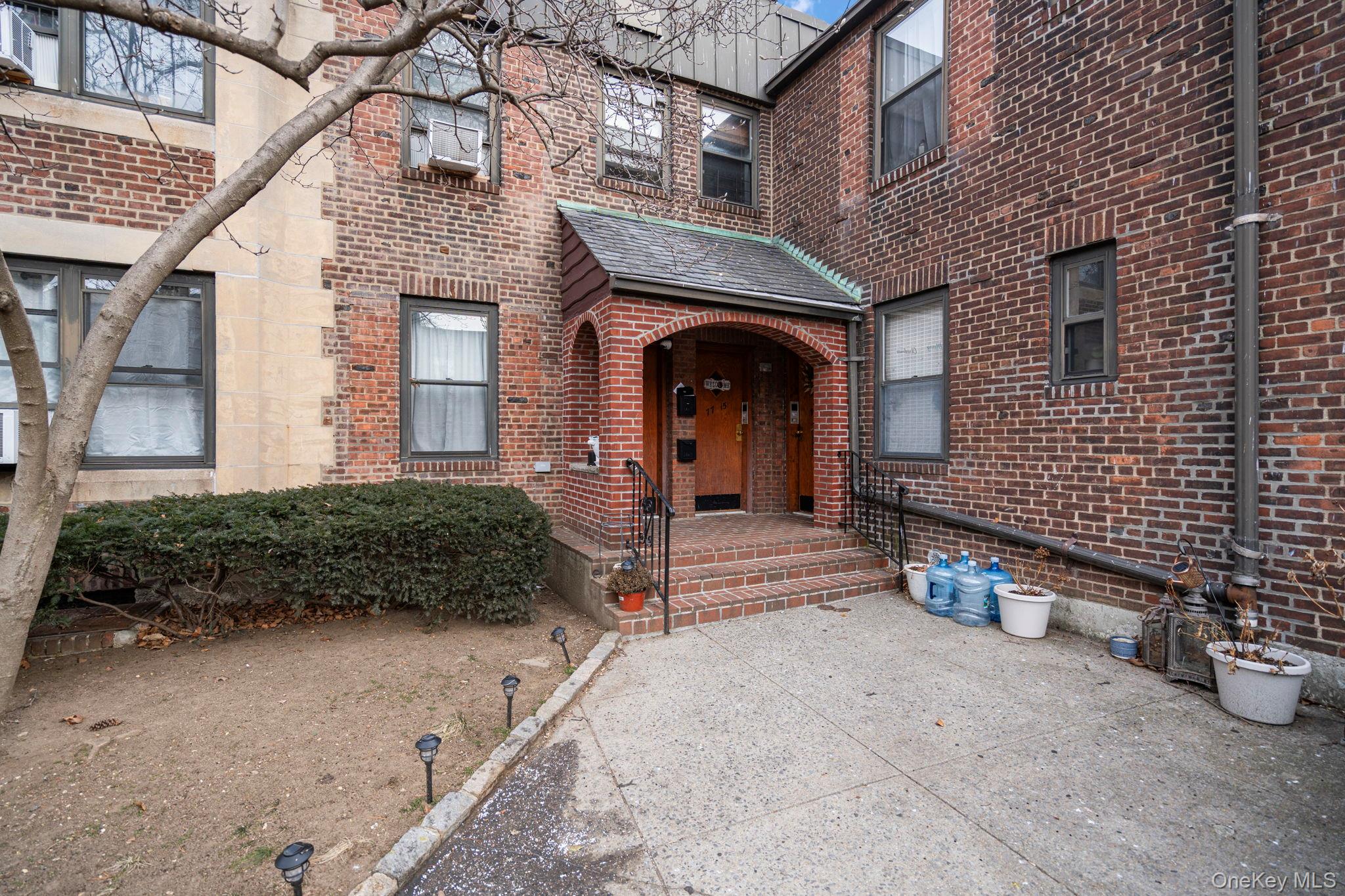 77-15 Ditmars Boulevard, Unit B2 Queens, NY 11370 - Photo 24 of 24 a front view of a house with a garden