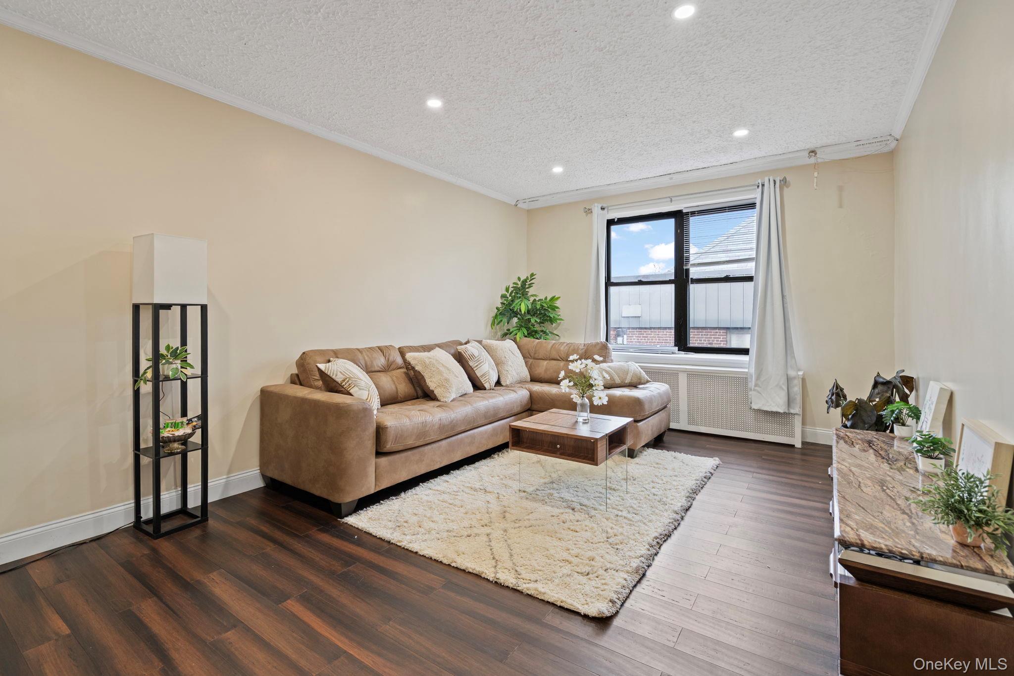 77-15 Ditmars Boulevard, Unit B2 Queens, NY 11370 - Photo 3 of 24 a living room with furniture and wooden floor