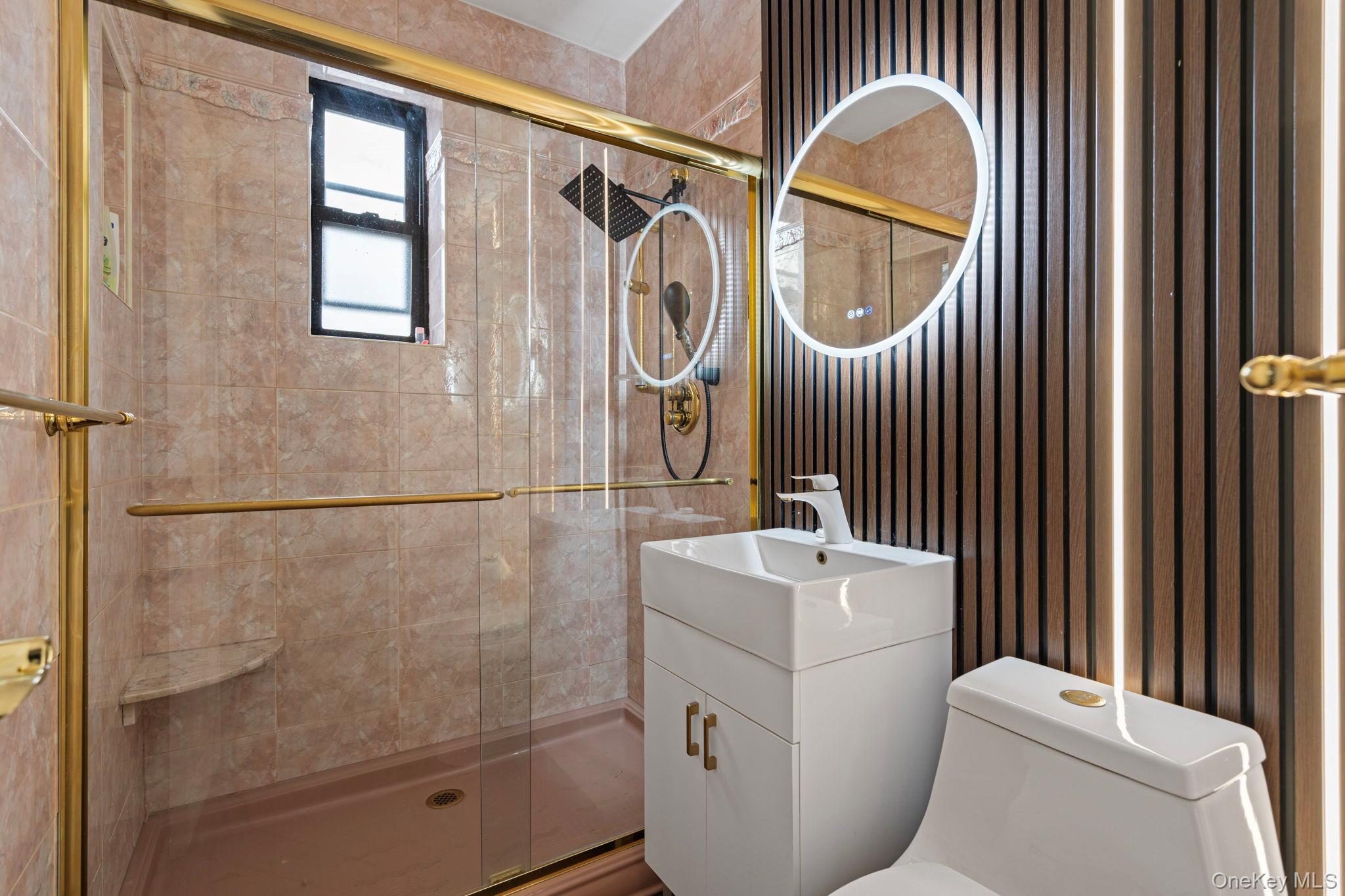 77-15 Ditmars Boulevard, Unit B2 Queens, NY 11370 - Photo 7 of 24 a bathroom with a sink a toilet and a mirror