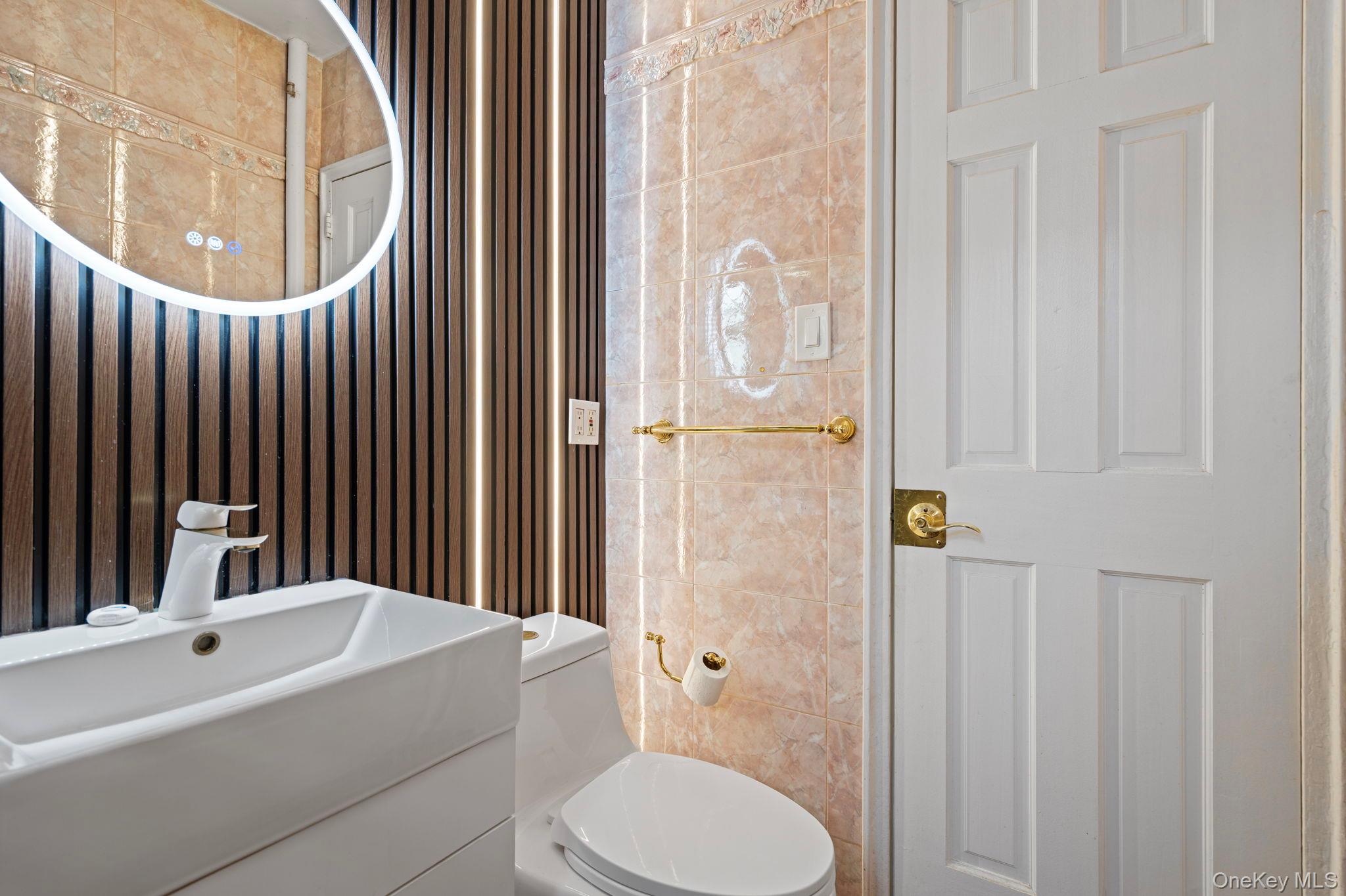 77-15 Ditmars Boulevard, Unit B2 Queens, NY 11370 - Photo 8 of 24 a bathroom with a sink a toilet and shower curtain