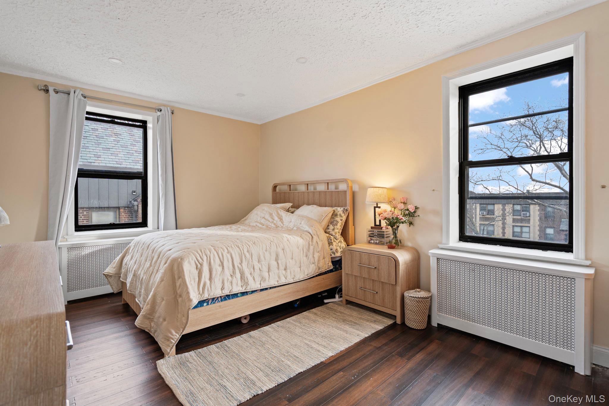 77-15 Ditmars Boulevard, Unit B2 Queens, NY 11370 - Photo 9 of 24 a bedroom with a bed and a window