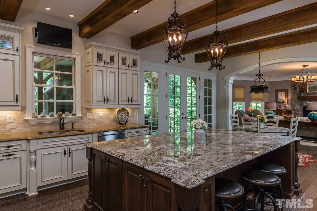 8841 Stage Ford Road Raleigh, NC 27615 - Photo 2 of 25 a kitchen with center island a counter space cabinets and appliances