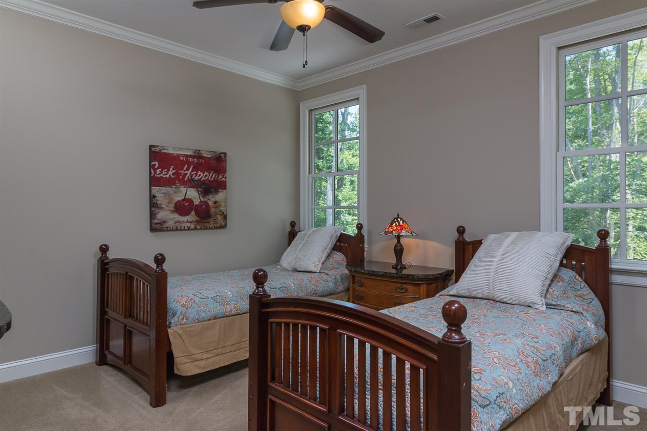 8841 Stage Ford Road Raleigh, NC 27615 - Photo 12 of 25 a bedroom with furniture and a chandelier