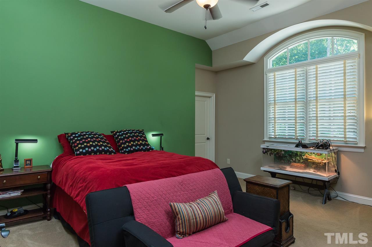 8841 Stage Ford Road Raleigh, NC 27615 - Photo 15 of 25 a bedroom with a bed chair and a window