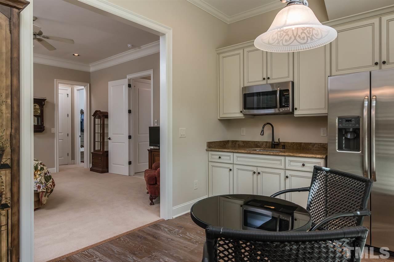 8841 Stage Ford Road Raleigh, NC 27615 - Photo 17 of 25 a kitchen with stainless steel appliances a refrigerator a sink a stove top oven a washer dryer and a dining table