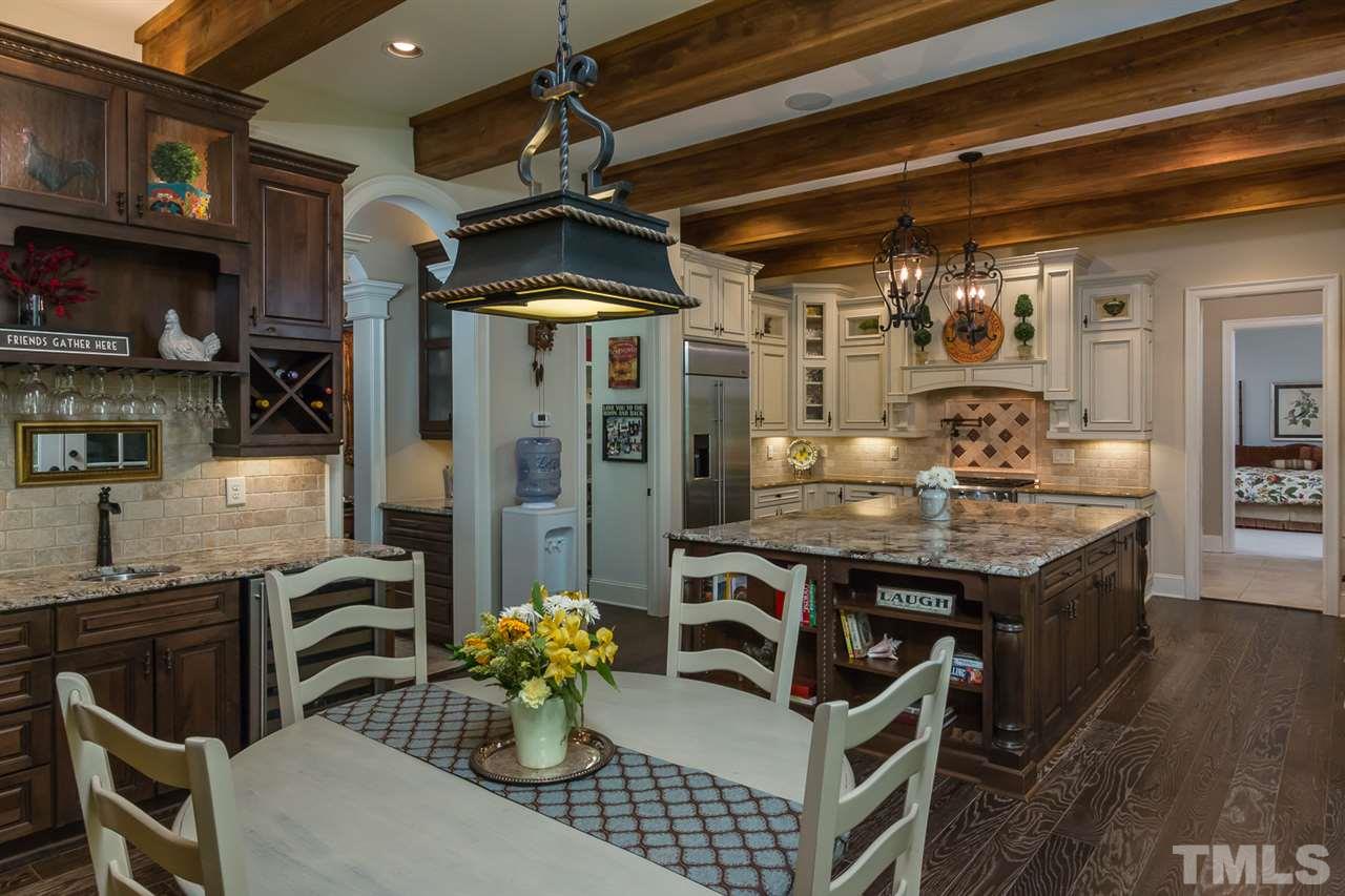8841 Stage Ford Road Raleigh, NC 27615 - Photo 3 of 25 a kitchen with stainless steel appliances granite countertop a stove and cabinets