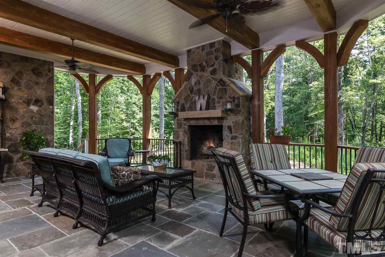 8841 Stage Ford Road Raleigh, NC 27615 - Photo 21 of 25 a view of a patio with a table chairs and a floor to ceiling window