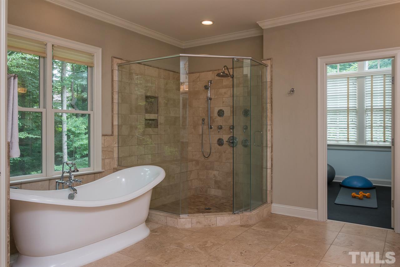 8841 Stage Ford Road Raleigh, NC 27615 - Photo 9 of 25 a bathroom with a bathtub and shower