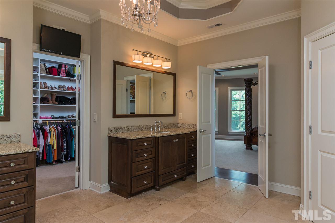 8841 Stage Ford Road Raleigh, NC 27615 - Photo 10 of 25 a spacious bathroom with a double vanity sink and a mirror