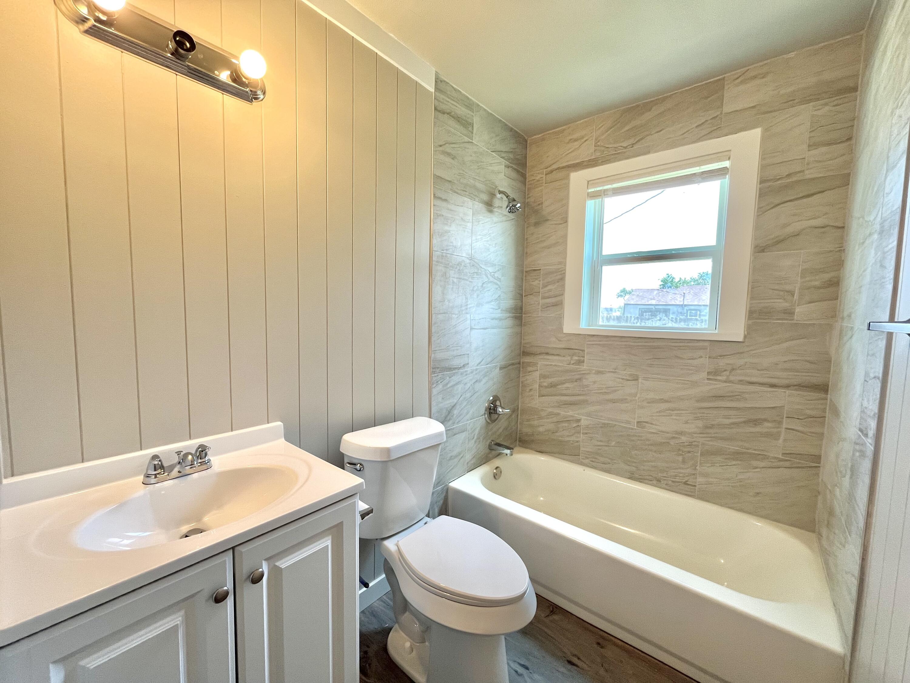 1510 East 10th Street Lubbock, TX 79403 - Photo 6 of 6 a bathroom with a sink toilet and shower
