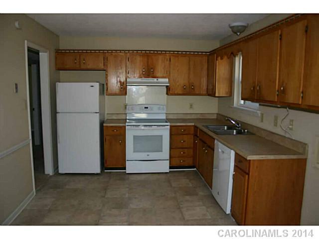 3317 Sandy Porter Road Charlotte, NC 28273 - Photo 7 of 12 a kitchen with a sink a stove and refrigerator
