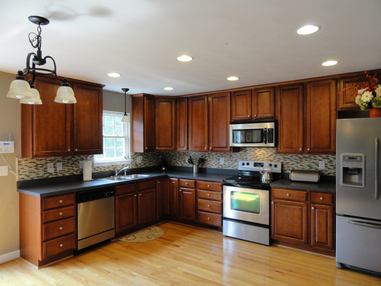 2826 Green Ridge Road Roanoke, VA 24019 - Photo 10 of 21 a kitchen with stainless steel appliances granite countertop wooden cabinets a stove top oven a sink and dishwasher with wooden floor