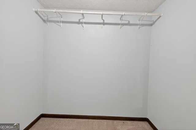 a bathroom with a granite countertop sink and a window