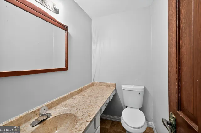a bathroom with a tub sink shower and mirror