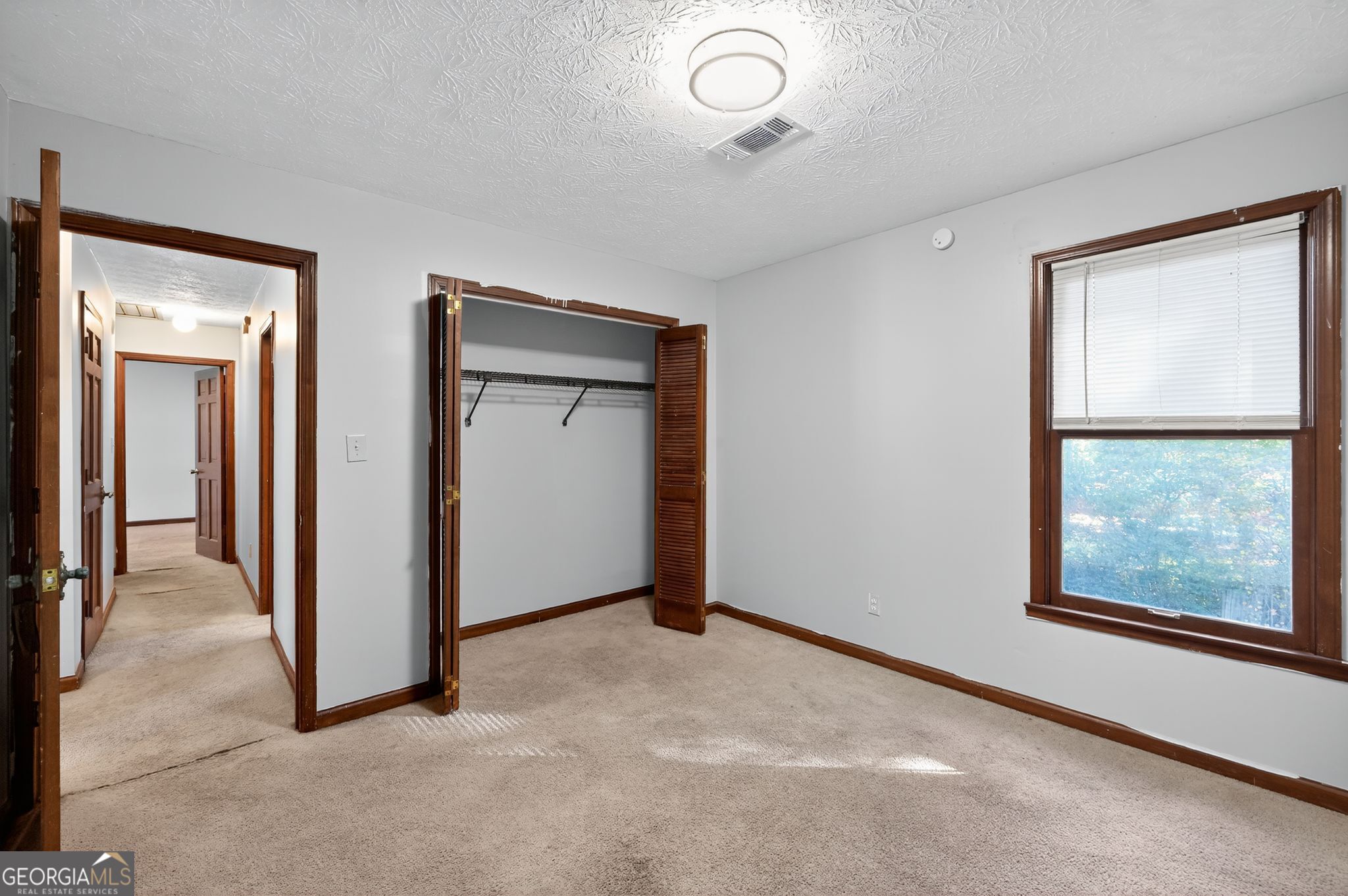 1378 Stoneleigh Hill Road Lithonia, GA 30058 - Photo 20 of 32 an empty room with windows and closet