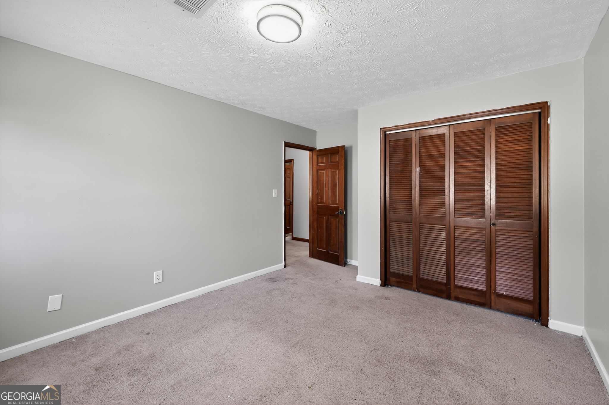 1378 Stoneleigh Hill Road Lithonia, GA 30058 - Photo 21 of 32 an empty room with windows