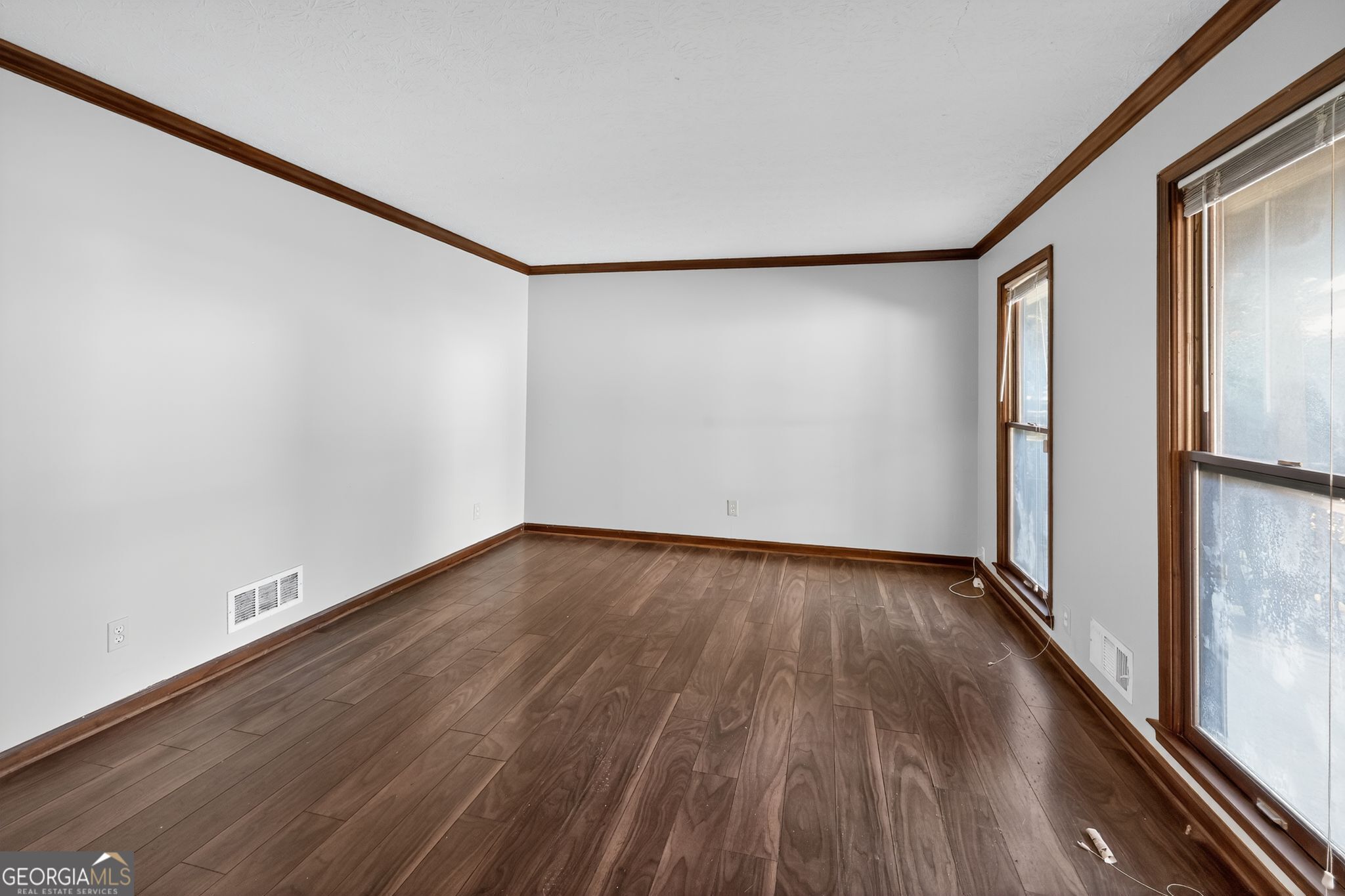 1378 Stoneleigh Hill Road Lithonia, GA 30058 - Photo 24 of 32 a view of an empty room with wooden floor and a window