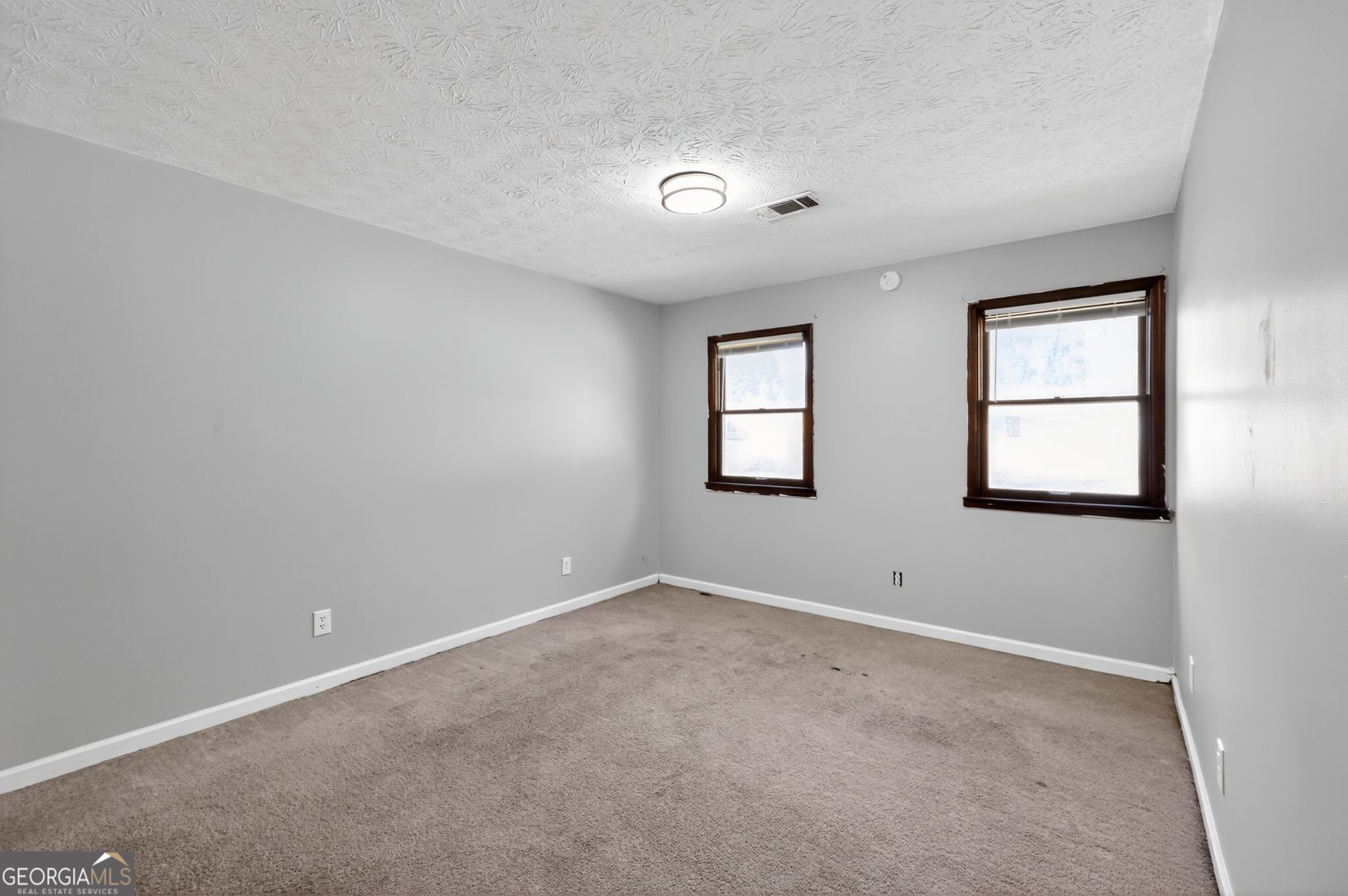 1378 Stoneleigh Hill Road Lithonia, GA 30058 - Photo 25 of 32 an empty room with windows