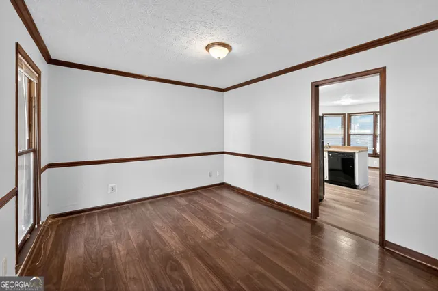 an empty room with closet and windows