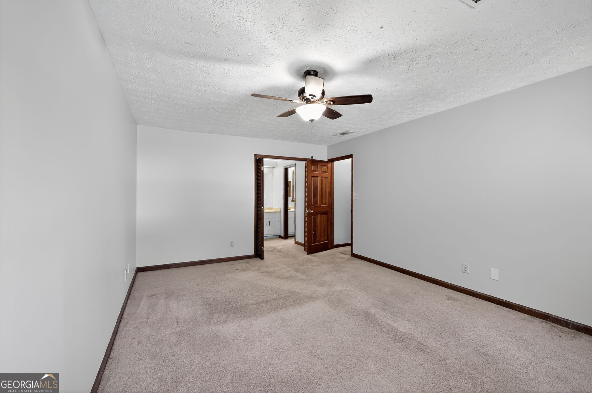 1378 Stoneleigh Hill Road Lithonia, GA 30058 - Photo 29 of 32 a view of an empty room with a ceiling fan