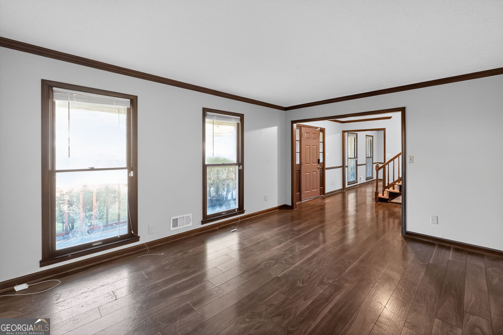 1378 Stoneleigh Hill Road Lithonia, GA 30058 - Photo 3 of 32 an empty room with wooden floor and windows