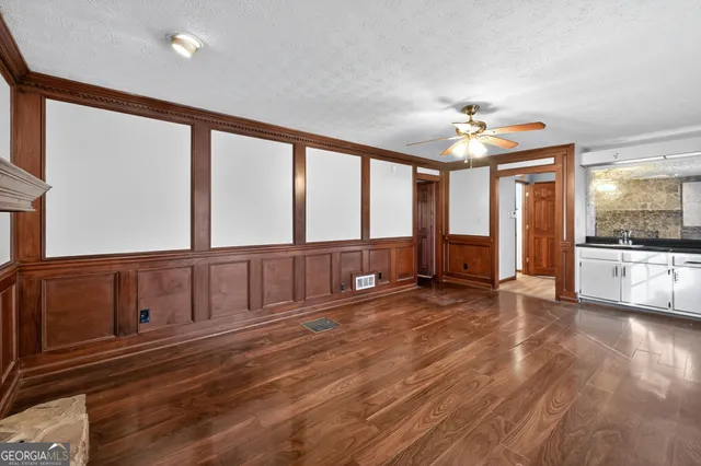 a view of an empty room with a kitchen