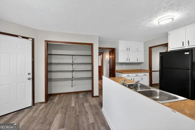 a kitchen with a refrigerator stove and sink