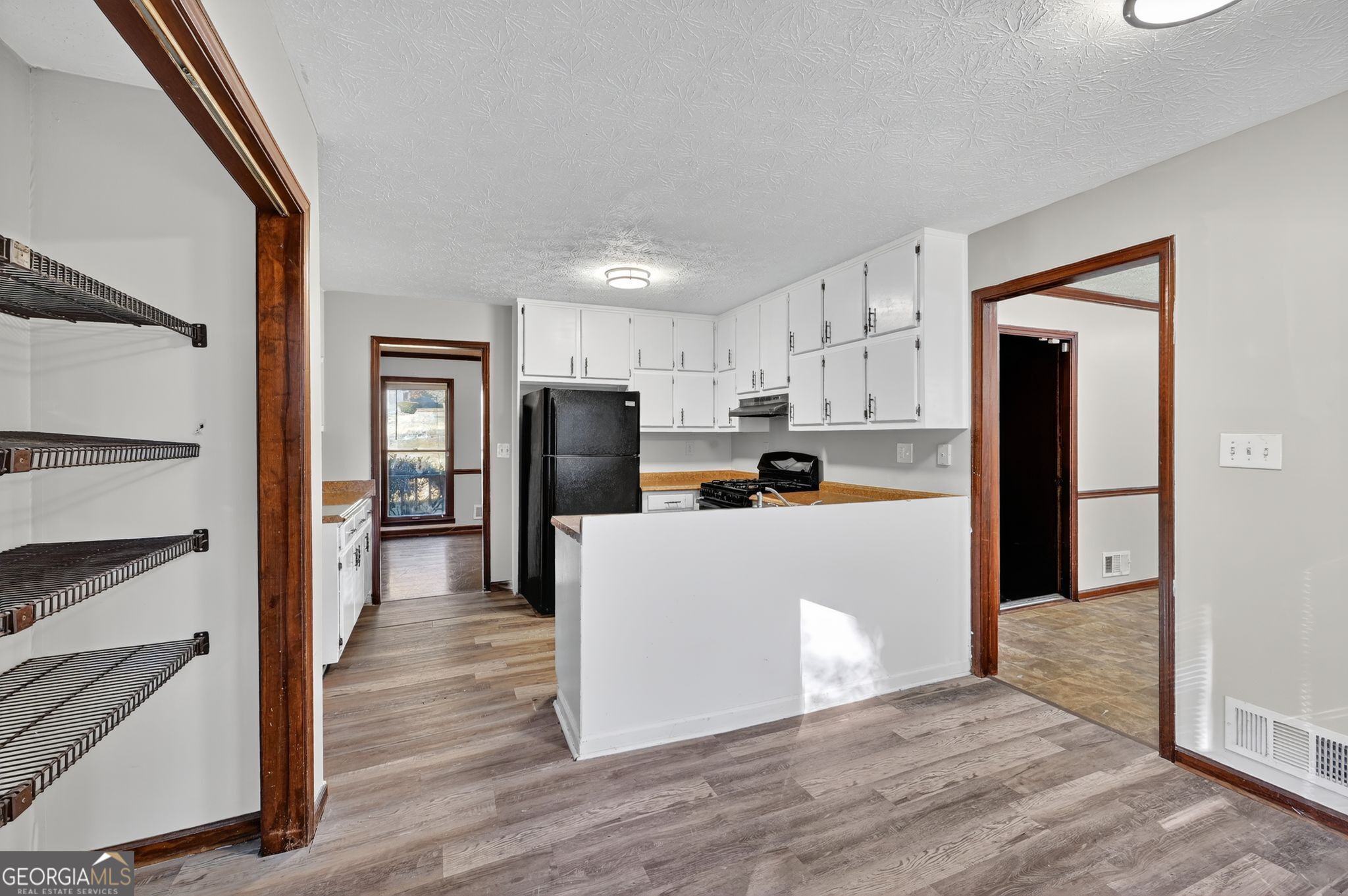 1378 Stoneleigh Hill Road Lithonia, GA 30058 - Photo 9 of 32 a kitchen with white cabinets and stainless steel appliances