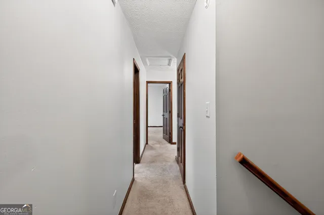 a view of a hallway with white walls