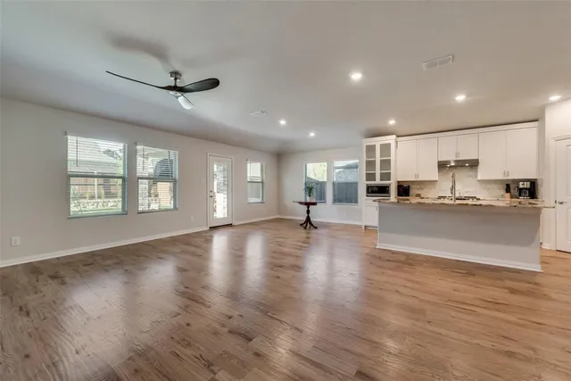 a view of kitchen with cabinets and wooden floor