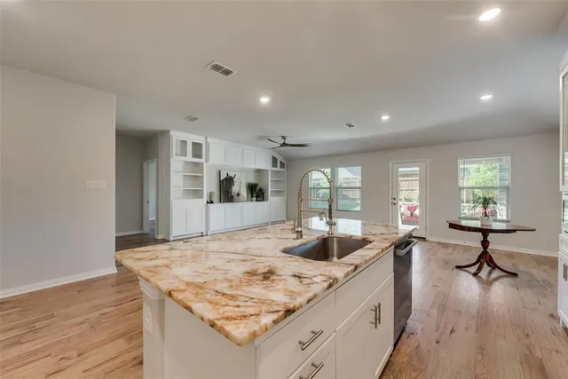 a view of kitchen island a sink and living room