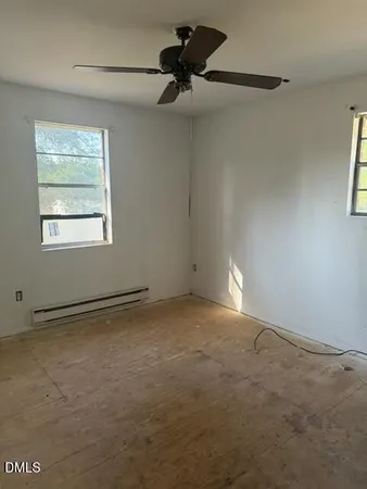 a view of an empty room and a window