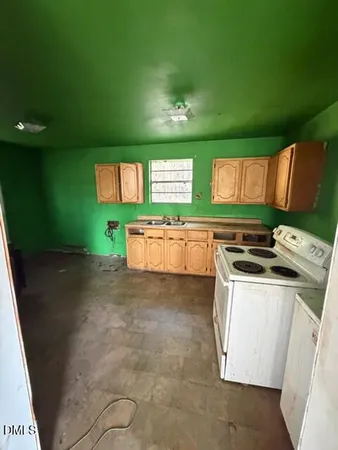 a view of a kitchen with stainless steel appliances granite countertop a stove a sink and dishwasher