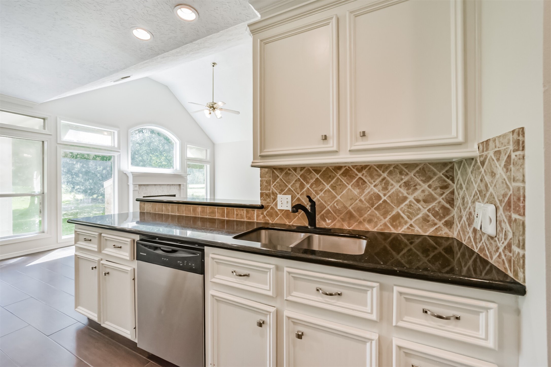27322 Afton Way Huffman, TX 77336 - Photo 20 of 50 Elegant kitchen details include granite countertops, custom cabinetry, designer backsplash, and an oversized breakfast bar perfect for gathering.