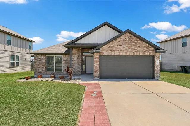 a front view of a house with a yard and porch