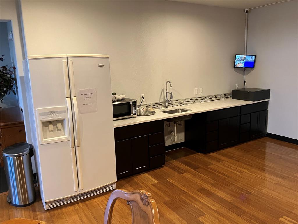 1220 West Trinity Mills Road, Unit 5009 Carrollton, TX 75006 - Photo 22 of 25 a kitchen with stainless steel appliances granite countertop a sink stove and refrigerator
