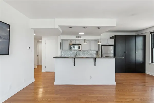 a view of kitchen with stainless steel appliances refrigerator oven and cabinets